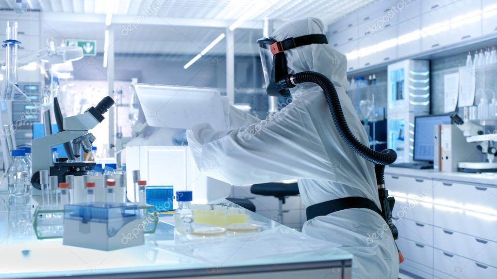 Medical Virology Research Scientist Works in a Hazmat Suit with 