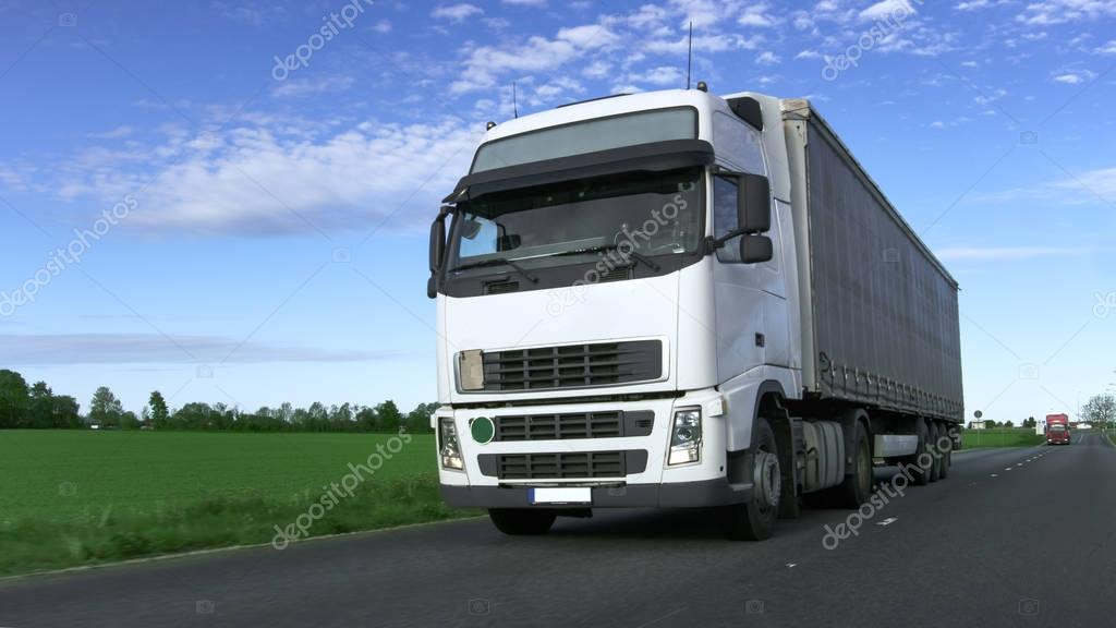 White Truck with Semi Trailer Driving on the Rural Road.