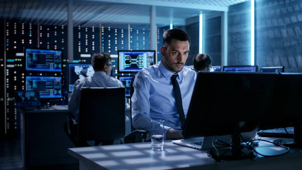 Close-up of Technical Engineer Working on His Computer With Mult