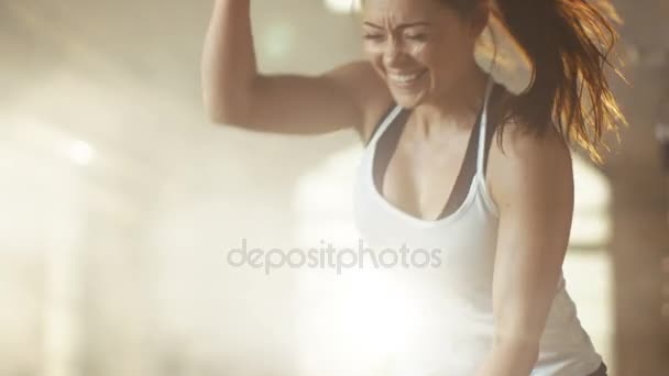 Athletic Female in a Gym Exercises with Battle Ropes During Her Cross Fitness Workout/ High-Intensity Interval Training. She's Muscular and Sweaty, Gym is in Industrial Building. — Stock Video