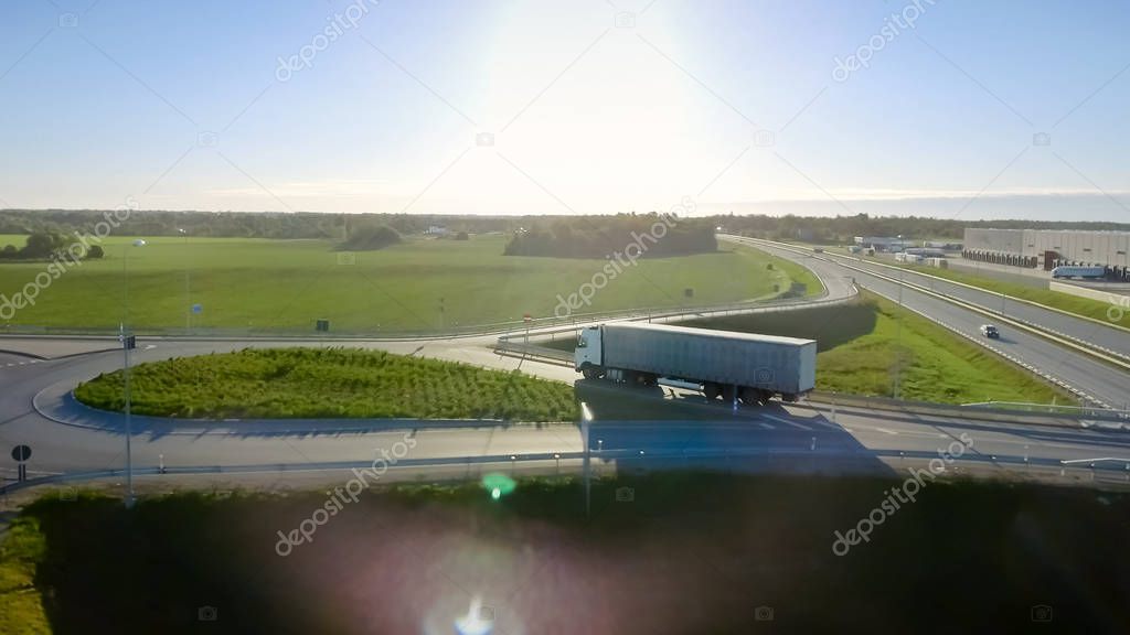 Aerial View of White Semi Truck with Cargo Trailer Passing Highw
