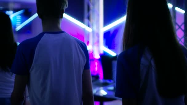 Suivi Prise de vue d'une équipe de joueurs adolescents marchant sur scène et prenant leur place dans un tournoi eSport / Jeux vidéo en ligne . — Video