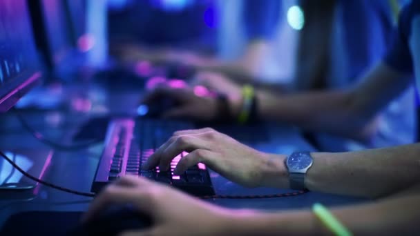 Close-up On Row of Gamer's Hands on a KeyBoard.jpgs, Actively Pushing Buttons, Playing MMO Games Online. Background is Lit with Neon Lights. — Stock Video