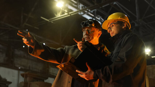 Engineer and Worker Have Conversation in Foundry. Engineer Using