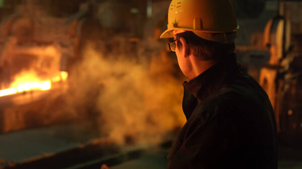 Portrait of Heavy Industry Technician in Hard Hat in Foundry. In