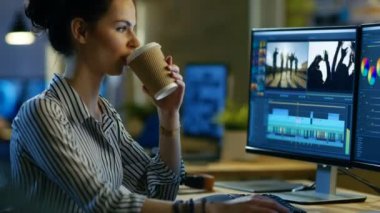 Erkek Video Editor görüntüleri ve ses onun kişisel bilgisayar üzerinde çalışır. Geç saatlere kadar çalışır ve kahve içiyor. Modern ve yaratıcı çatı stüdyo ofisinde olduğunu.