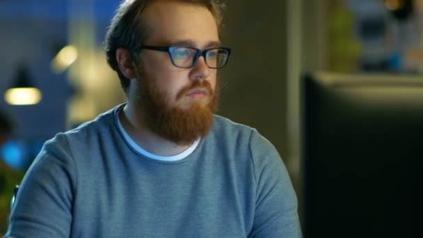 Young Bearded Creative Man Thinks on a Problem While Working on His Personal Computer. — Stock Video