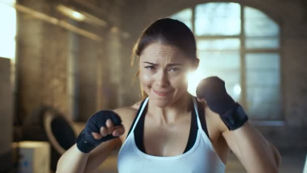 Beautiful Athletic Woman Punches Air with Her Fists as Part of Her Intensive Cross Fitness Gym Training. — Stock Video