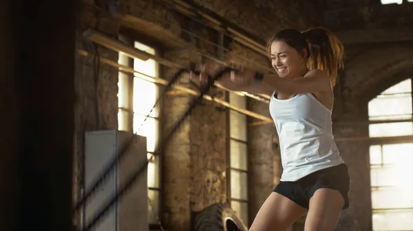 Athletic Female in a Gym Exercises with Battle Ropes During Her — Stock Photo, Image