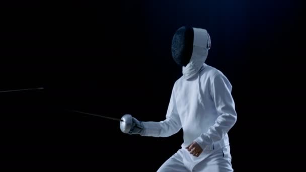 Two Professional Fencers Show Masterful Swordsmanship in their Foil Fight. They Attack, Defend, Leap and Thrust and Lunge. Shot Isolated on Black Background  and in Slow Motion. — Stock Video