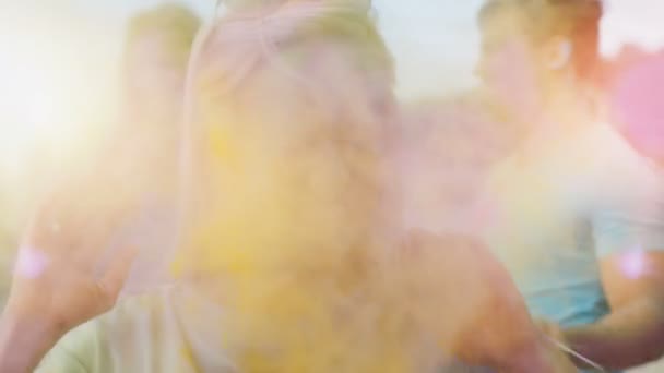 Close-up Portrait of a Beautiful Blonde Girl Dances in Celebration of Holi Festival With Her Friends. Her Face and Clothes are Covered with Colorful Powder. — Stock Video