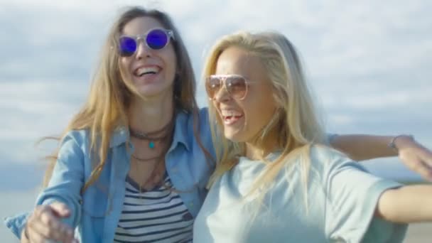 Two Beautiful Happy Girls Laugh and Celebrate Holi Festival  Colorful Powder Flying Behind They're Backs. They Have Time of Their Lives. — Stock Video