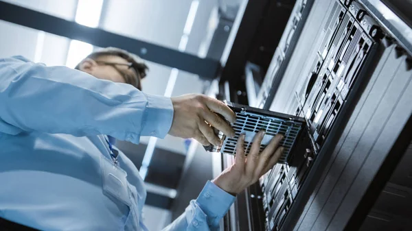 Low Angle Shot In Fully Working Data Center IT Engineer Installs Hard Drive into Server Rack. Detailed and Technically Accurate Footage. — Stock Photo, Image