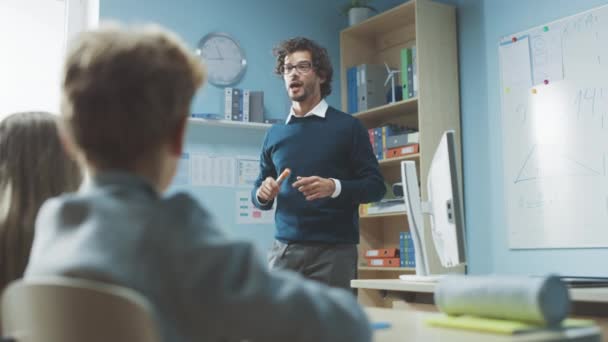 Enthusiastischer Lehrer erklärt einem Klassenzimmer voller bunt gemischter Kinder die Lektion und leitet den Unterricht mit Fragen. In der Grundschulgruppe lernen multiethnische Kinder. Slow Motion Bogenschuss — Stockvideo