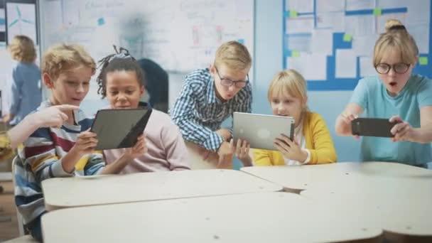 School Computer Science Class: Schoolchildren Use Digital Tablet Computers and Smartphones with Augmented Reality Software, Theyre Excited, Full of Wonder. Children in STEM, Playing and Learning — Stock Video