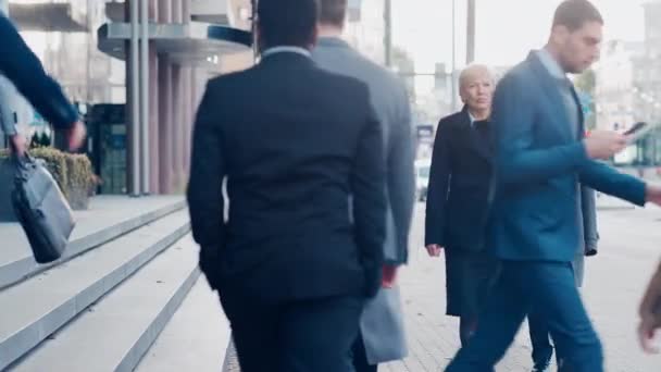 Diverse and Multicultural Office Managers and Business People Commute to Work in the Morning or from Office on a Cloudy Day on Foot. Pedestrians are Smart Casually Dressed. People Using Smartphones. — Stock Video