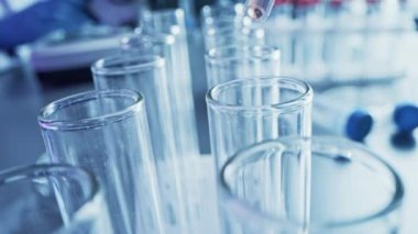 İlaç Laboratuvarı: Sıvıyı Test Tüplerine Bırakma, Tıbbi Araştırma ve Analiz. Bilimsel Laboratuvar; Damlatan, DNA araştırması için kullanılan biyokimyasal sıvıyla örnek tüplerini dolduruyor. Makro 'yu yakın plan