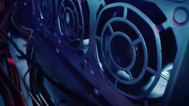 Gros plan Macro Shot : Inside of the Computer Case. Caméra se déplace à côté de la rangée de ventilateurs de refroidissement, avec plusieurs câbles d'alimentation connectés. Appareil électronique intérieur. Élégant néon, noir, rose, bleu 