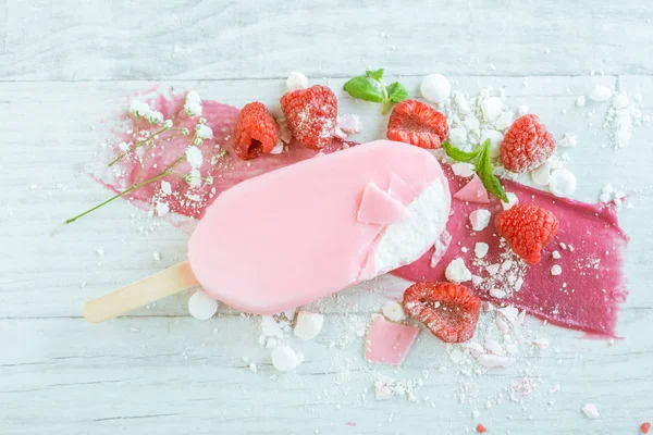 Ice cream in pink chocolate and raspberries — Stock Photo, Image