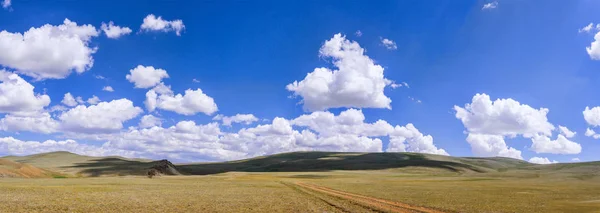 Bolyhos felhők zöld dombokon — Stock Fotó