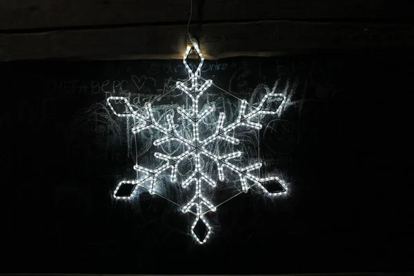Lichtgevende Kerstsneeuwvlok Uit Een Bloemenslinger — Stockfoto