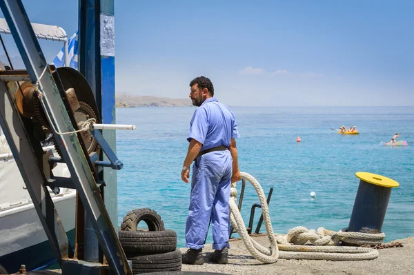 Man with rope at port of Loutro town on Crete island, Greece. — Stock Photo, Image