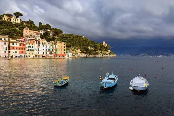 Cielo tempestoso e piccole barche nella baia marina della città di Portofino. Portofino è una piccola città di pescatori in Liguria in Italia . — Foto Stock