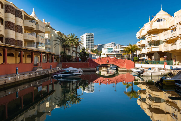 PUERTO MARINA, BENALMADENA - ДЕКАБРЬ 2019: Beautiful villages surrounded with water, private port and parked yachts, Andalusia, Spain

