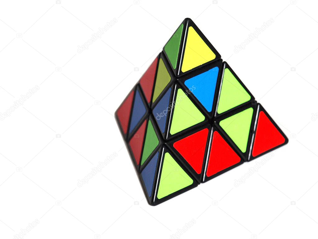 Triangular puzzle cube in a shape of a pyramid isolated on white background