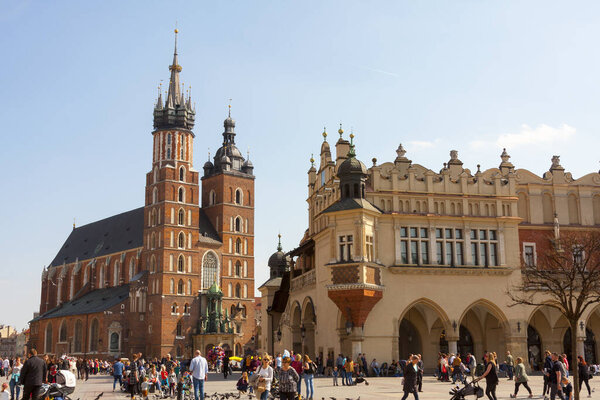 St. Mary's Basilica (Church of Our Lady Assumed into Heaven) in Krakow / Cracow, Poland, view during daytime, cloth hall, a plane in the sky, landmarks of Cracow