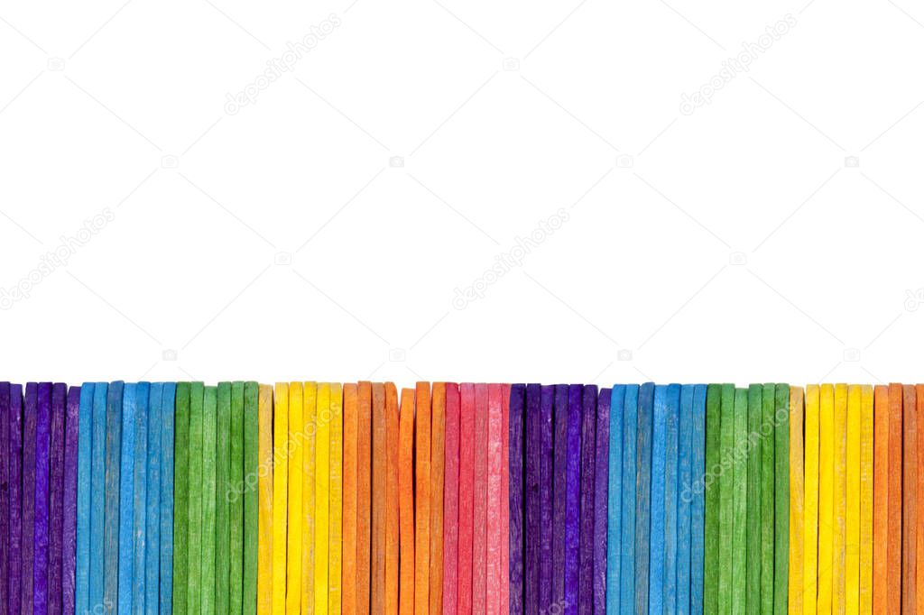 Abstract background, a simple fence border made of ice cream / popsicle sticks alligned in a pattern, a single row isolated on white. Eco friendly materials texture, school education concept