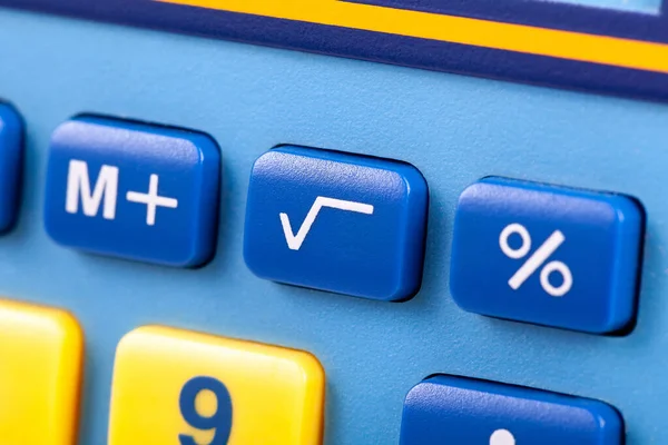 Simple square root symbol button on a colorful calculator keypad macro, closeup. Basic algebra symbols, easy math nomenclature, learning mathematics, finances, early education, teaching aids concept