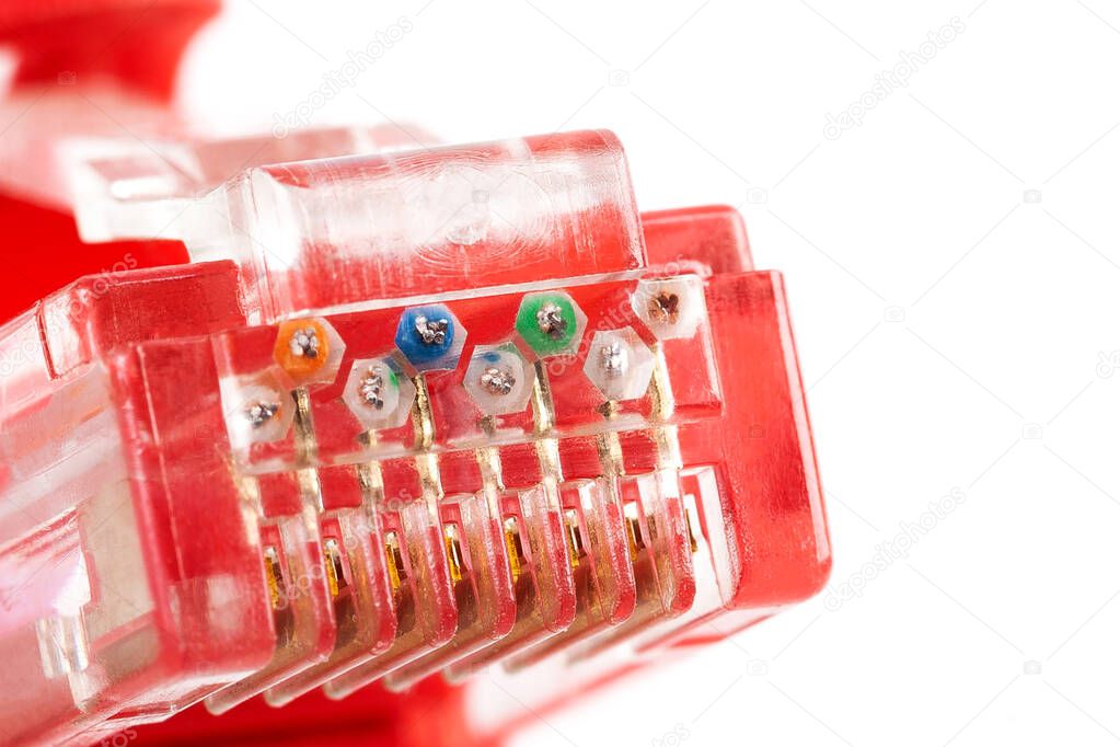 8P8C, RJ-45 crimped red ethernet connector macro, extreme closeup on end, pins, unshielded twisted pair UTP internet cable up close. Individual colored cables visible. Cable crimp, crimping concept