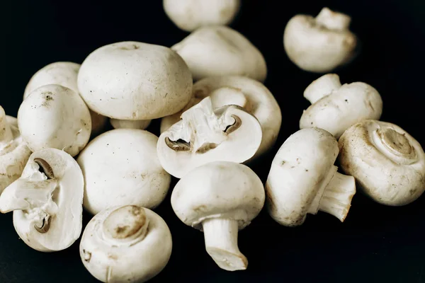 champignon mushrooms on a black background. space for text