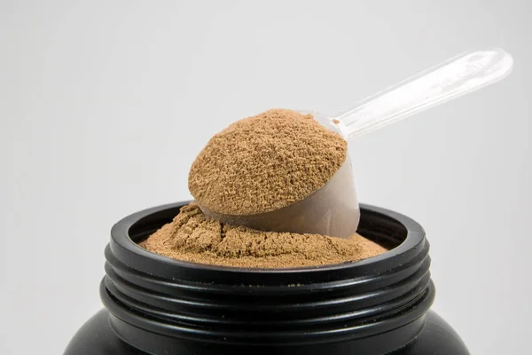 A cup of whey protein powder for muscle gains or diet person is