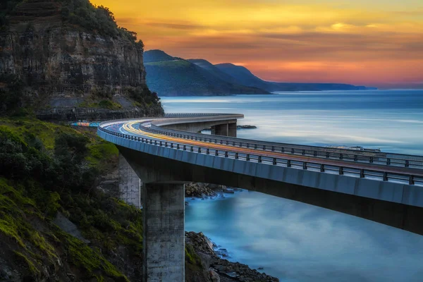 Pôr do sol sobre a ponte do penhasco do mar ao longo do oceano Pacífico australiano — Fotografia de Stock