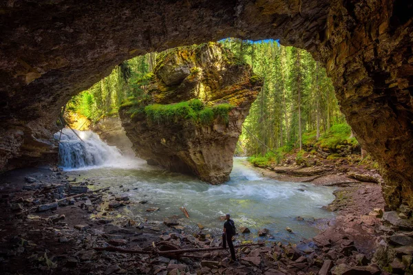 Caminhante assistindo Johnston Creek de uma caverna — Fotografia de Stock