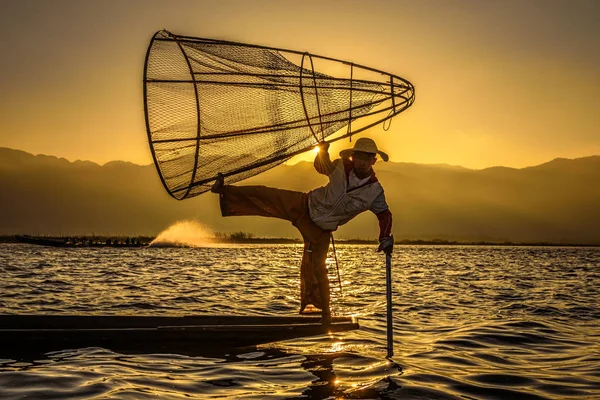 Pescador birmanês em um barco de bambu ao nascer do sol — Fotografia de Stock