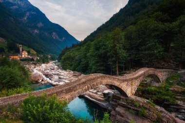 Historic bridge called Ponte dei Salti in the village of Lavertezzo, Switzerland clipart