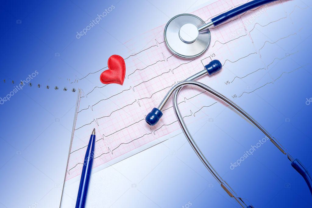 Close-up of healthy electrocardiogram results. A tool for studying breathing and heartbeat. Blue doctor's stethoscope. The concept of maintaining a healthy heart.