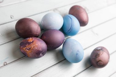 Açık ahşap bir masada renkli Paskalya yumurtaları. Tavuk yumurtaları Paskalya tatili için boyanır..