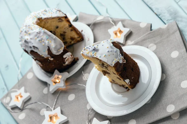 Festive cake for the Easter holiday. Delicious sweet cake. A cake on a table made of light blue boards. Still life on the theme of Easter.