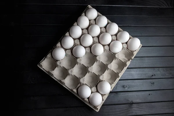 chicken eggs in a cardboard egg tray. White chicken eggs. Agricultural industry. Natural protein.