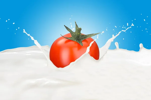 Tomato in milk splash — Stock Photo, Image