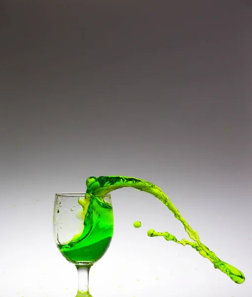 splash of green water inside the glass