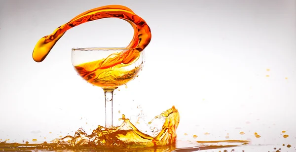 splash of orange water inside the glass