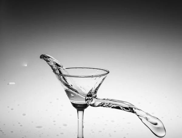 black and white splash water in a glass, by splashing water in the background