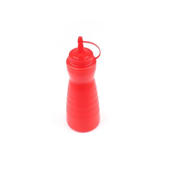 red plastic sauce bottle on white background