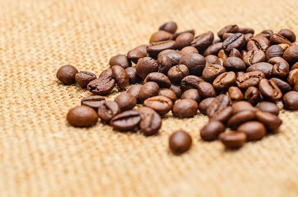 Coffee beans on burlap background — Stock Photo, Image