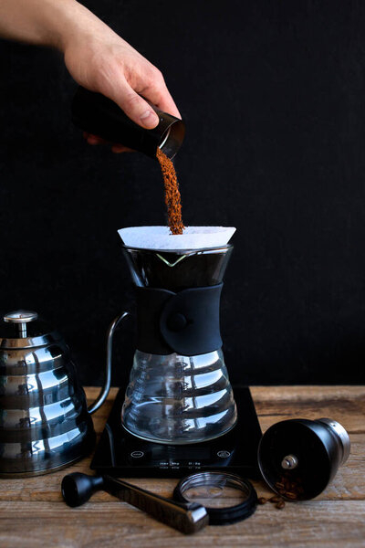 Ground coffee in the funnel.The ritual of making coffee.Making coffee at home.Filtered or overflow is a method that includes pulping water on rogated ground coffee beans contained in a filter
